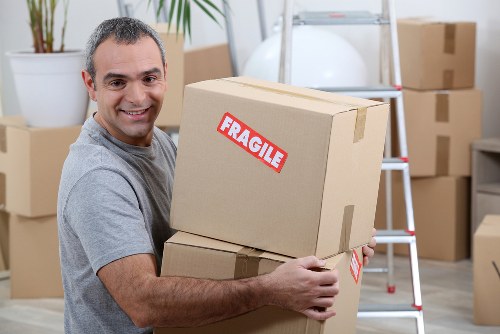 Moving team handling flat removals in Ham outside an apartment building