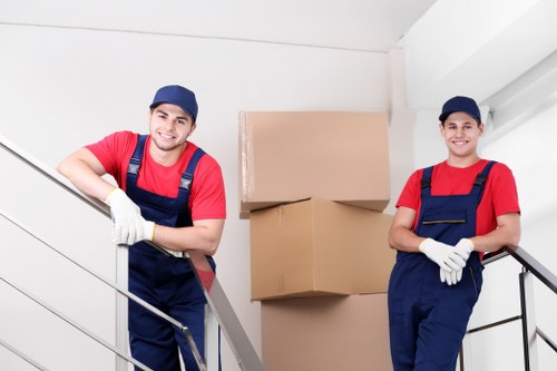 A moving team preparing boxes for Ham removals in a residential property