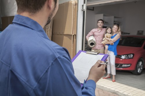 Professional movers handling office equipment during removals in Ham