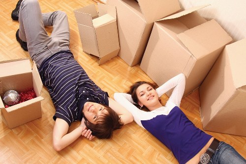 House removalists carefully moving furniture into a truck in Ham